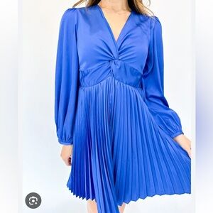 Blue boutique mini dress with pleated skirt and twist front v-neck. Size XS.